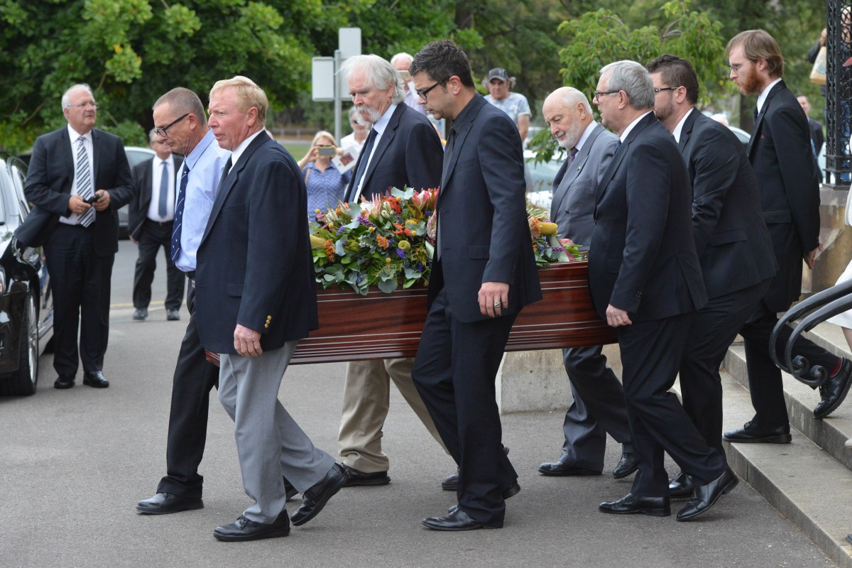 Pallbearers, including step-son Dylan Lewis and former South Australian Premier Mike Rann carry the coffin of John Bannon at St Peter's Cathedral, Adelaide, Monday, Dec. 21, 2015. (AAP Image/Brenton Edwards) NO ARCHIVING