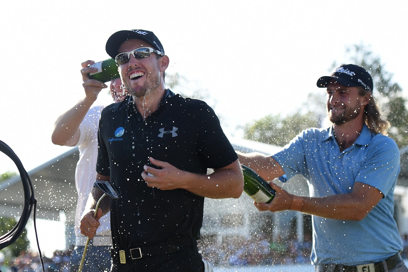 Nathan Holman is doused with champagne after winning the Australian PGA Championship at the Royal Pines resort on the Gold Coast. AAP Image/Dan Peled