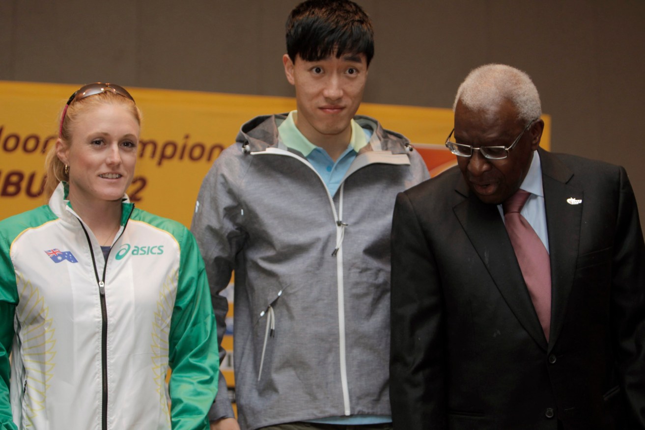 Former IAAF president Lamine Diack poses with Australia's World Champion Sally Pearson and Liu Xiang of China in 2012. Photo: TOLGA BOZOGLU, EPA.