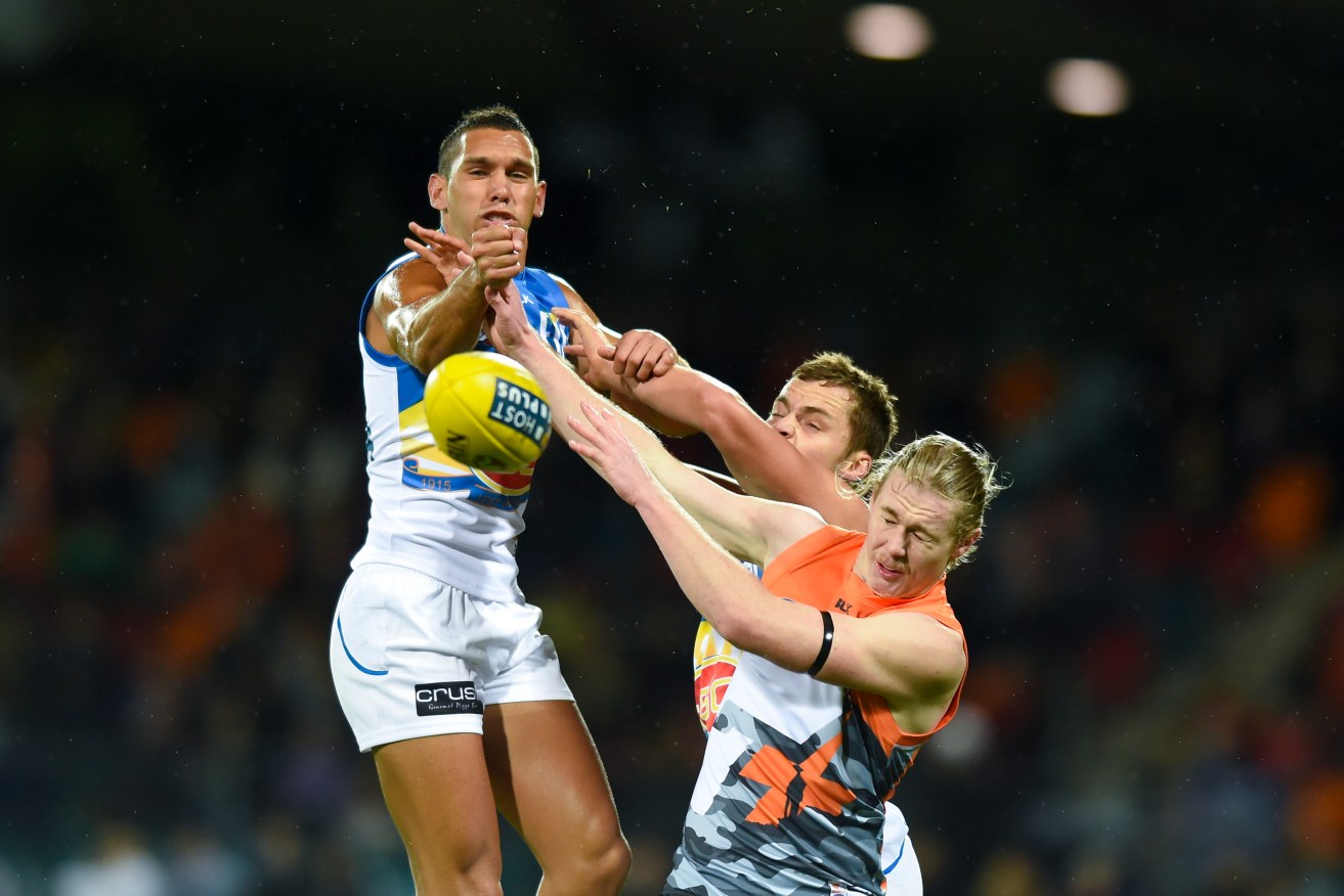 Cameron McCarthy (right) challenges Harley Bennell for the ball. AAP Image/Lukas Coch