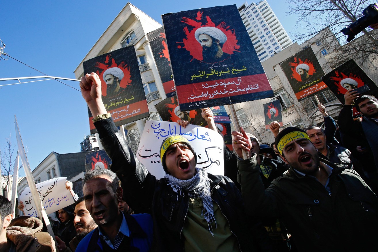 Iranian protestors hold posters of late Shiite cleric Nimr al-Nimr during a demonstration near the Saudi Arabian embassy in Tehran. Photo: ABEDIN TAHERKENAREH, EPA