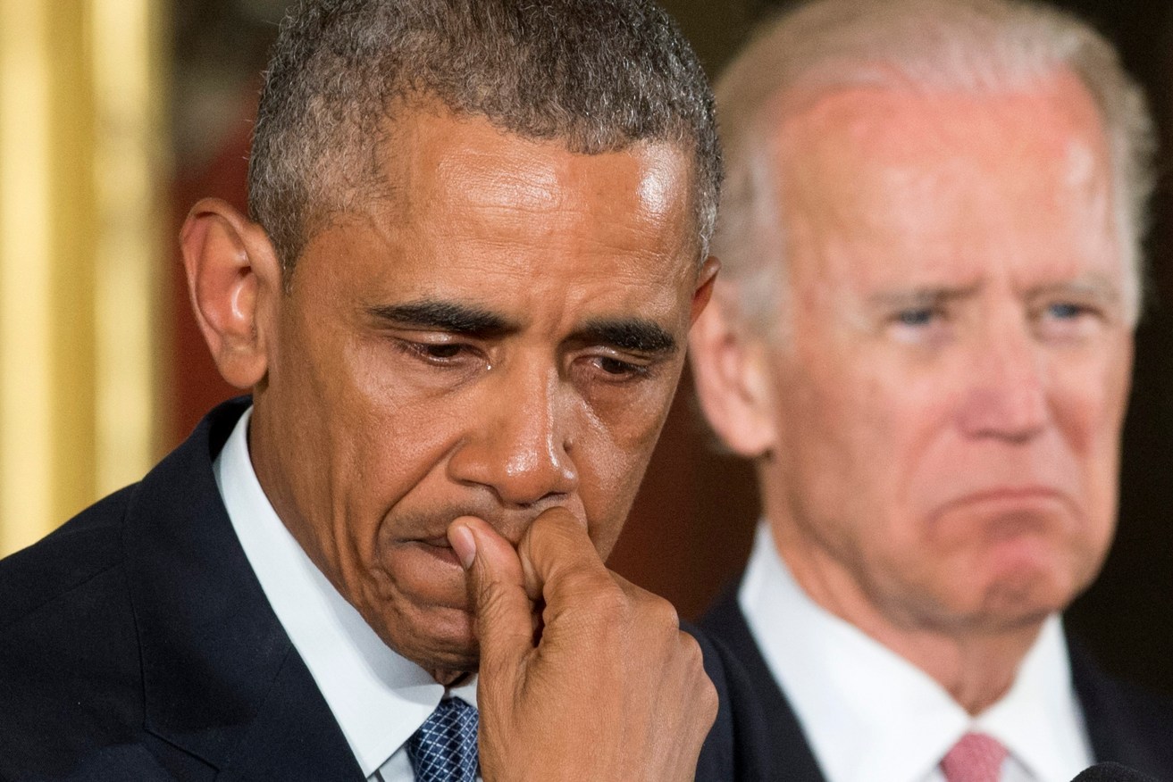 US President Barack Obama becomes emotional while announcing executive actions to reduce gun violence, flanked by Vice President Joe Biden. Photo: MICHAEL REYNOLDS, EPA