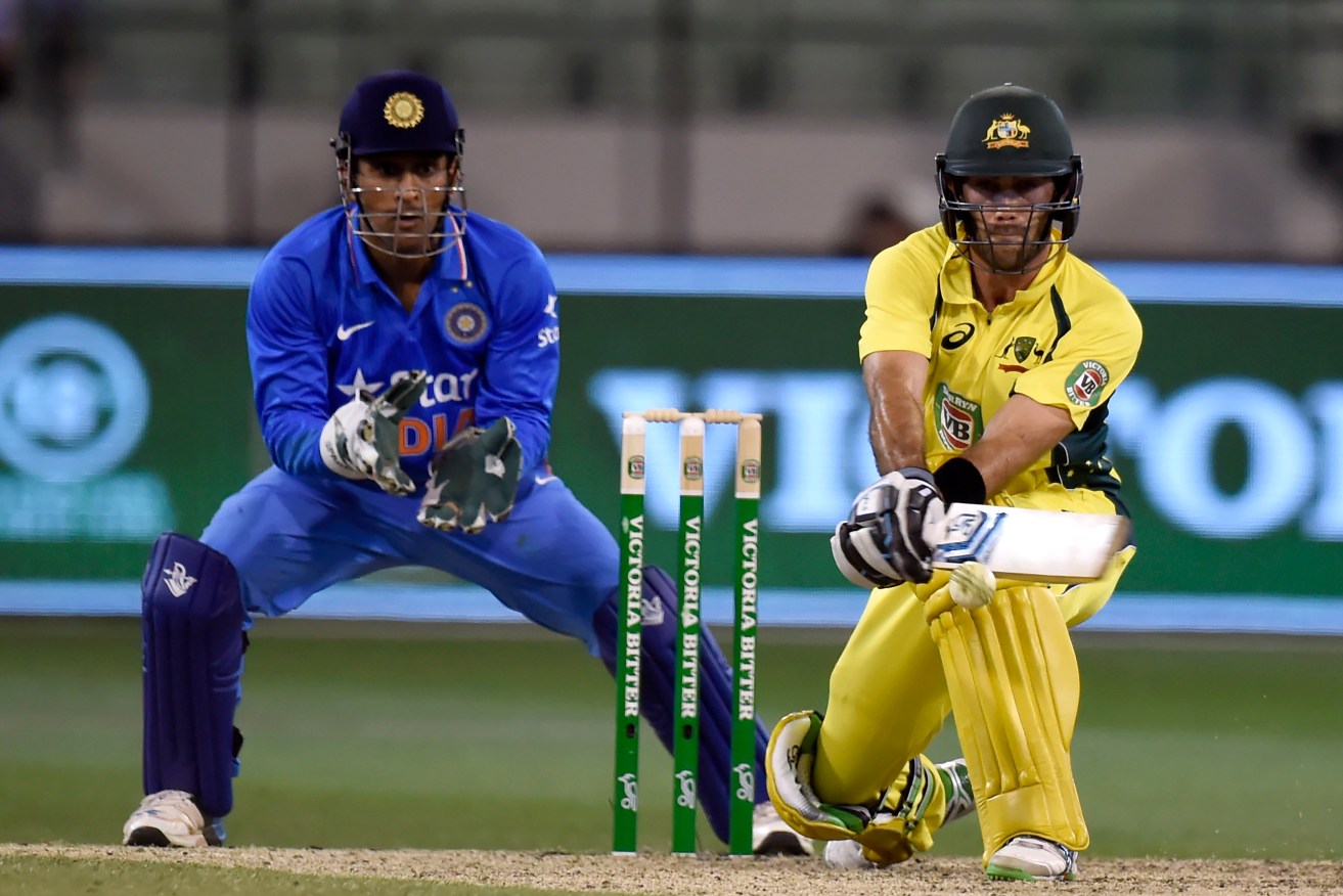 Glenn Maxwell plays a reverse sweep infront of MS Dhoni during his match-saving ODI innings. Photo: Mal Fairclough, AAP.