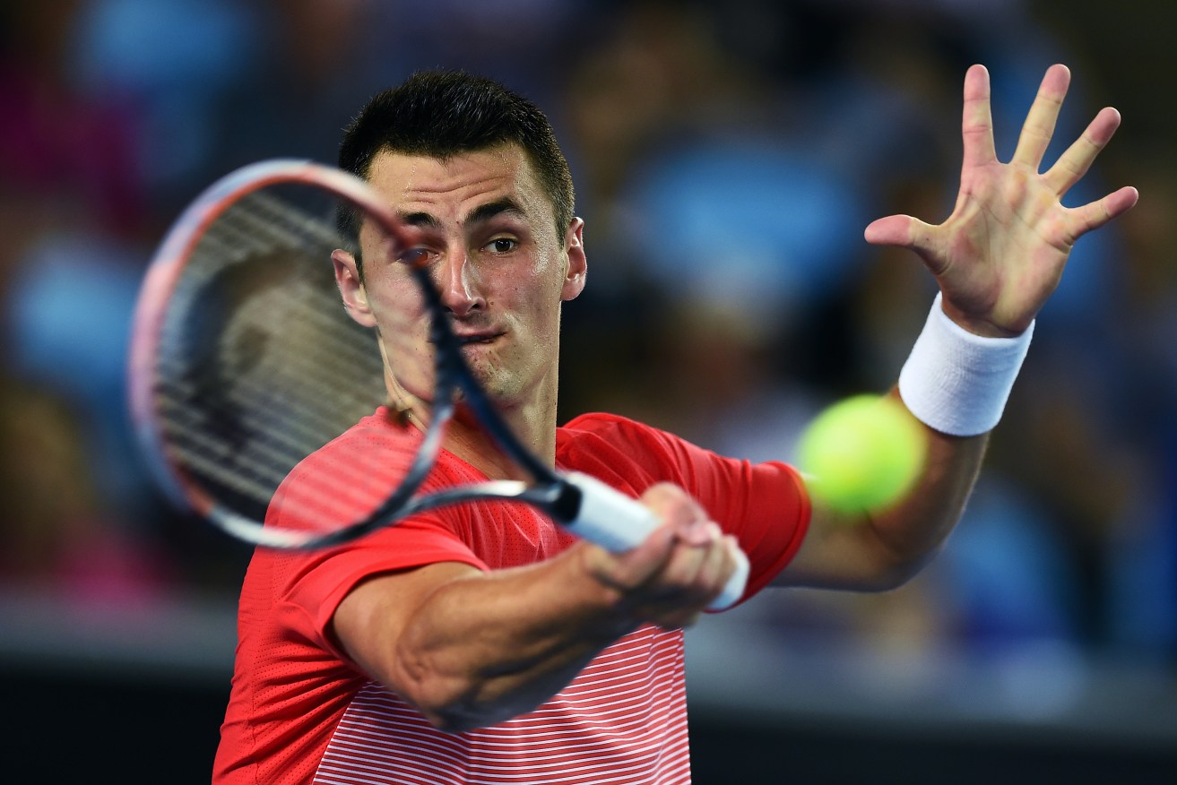 Bernard Tomic on his way to victory over Simone Bolelli. AAP Image/Lukas Coch