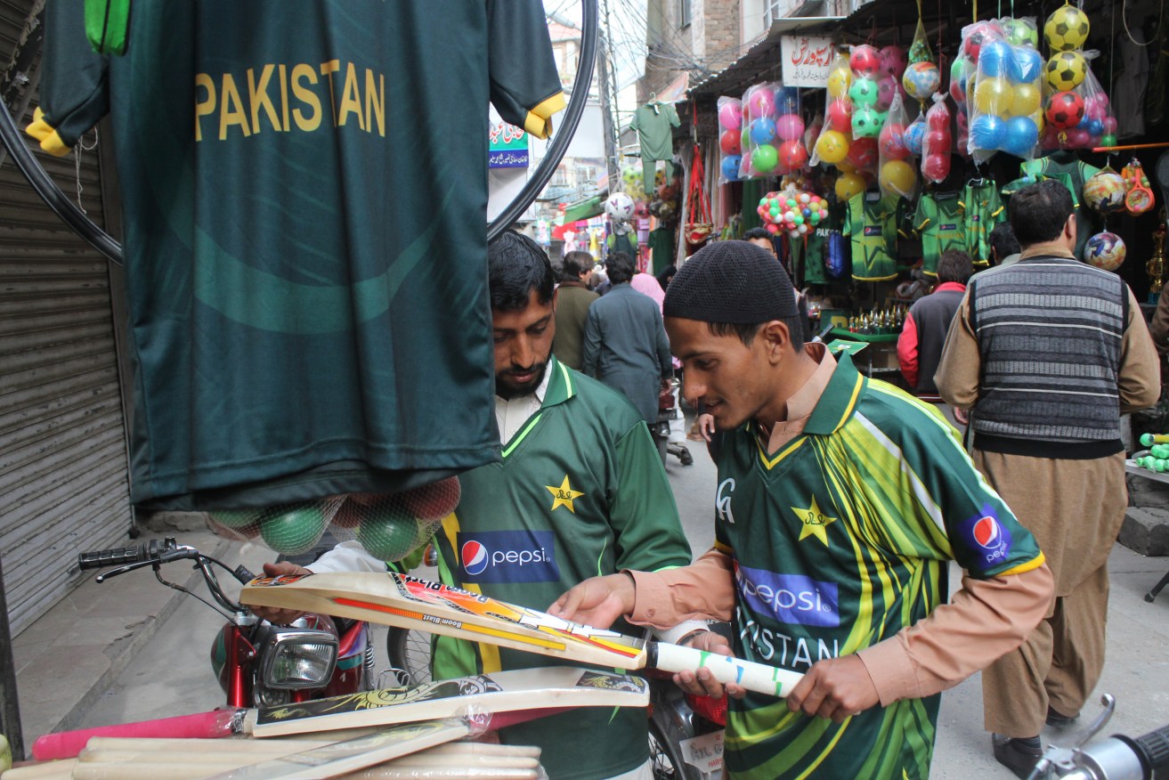 Shopkeepers sell Pakistan's national cricket team jerseys to customers. Photo: KHURRAM BUTT, NewZulu/AAP.