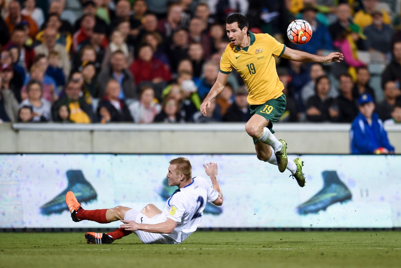 Socceroo Ryan McGowan fights Kyrgyzstan's Valerii Kichin for the ball during last year's World Cup qualifier. Photo: Lukas Coch, AAP.