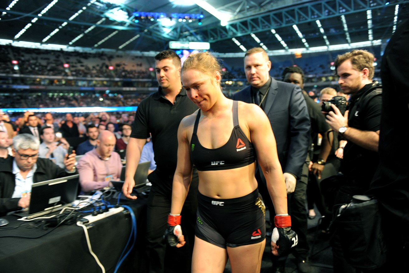 Ronda Rousey leaves the octagon after her defeat against Holly Holm. Photo: Joe Castro, AAP.