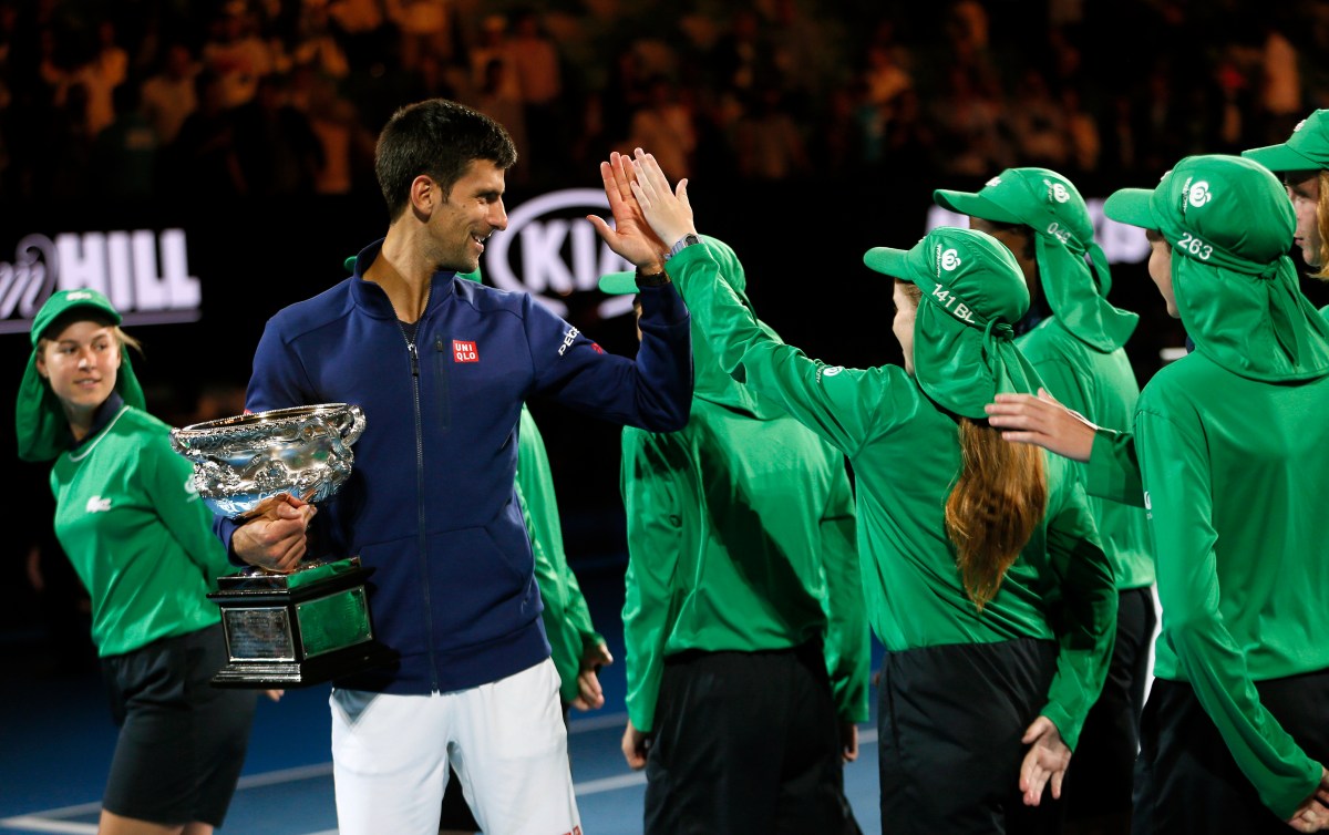 Novak Djokovic of Serbia receives congratulations by the ballboys and girls after winning the Men's Final against Andy Murray of Britain at the Australian Open tennis tournament in Melbourne, Australia, 31 January 2016. (AAP Image/Made Nagi) NO ARCHIVING, EDITORIAL USE ONLY