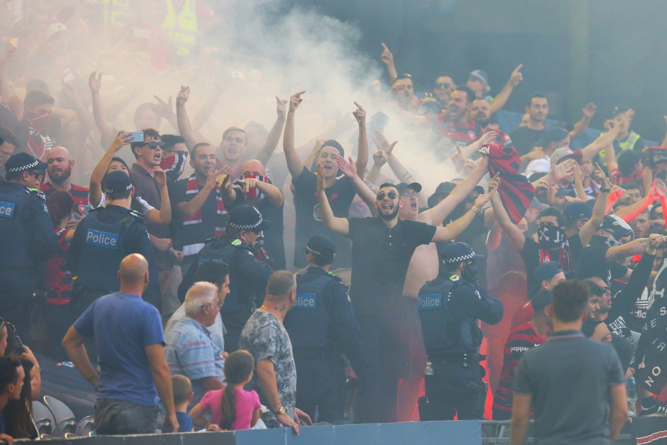Wanderer fans let off flares during the round 18 A-League match. Photo: David Crosling, AAP.