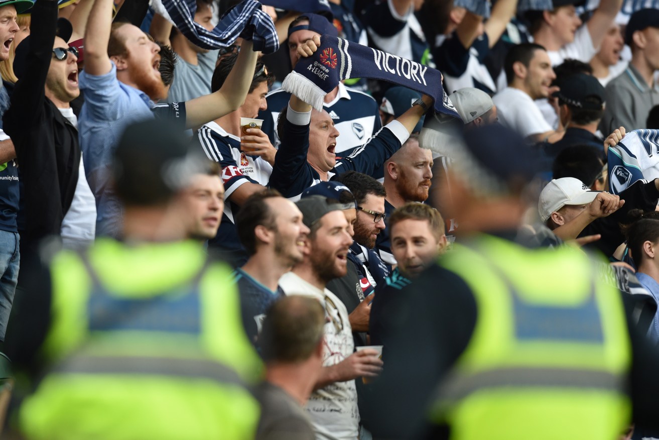 Police watch Melbourne Victory fans chant during last week's match against Melbourne City. Photo: Tracey Nearmy, AAP.
