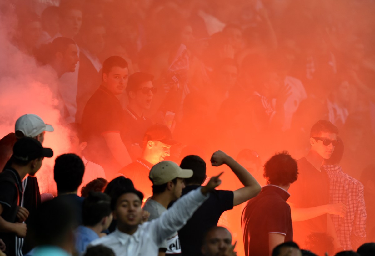 Melbourne Victory fans light a flare during the Melbourne City and Melbourne Victory A League round 19 match at AAMI Park in Melbourne, Saturday, Feb. 13, 2016. (AAP Image/Tracey Nearmy) NO ARCHIVING, EDITORIAL USE ONLY