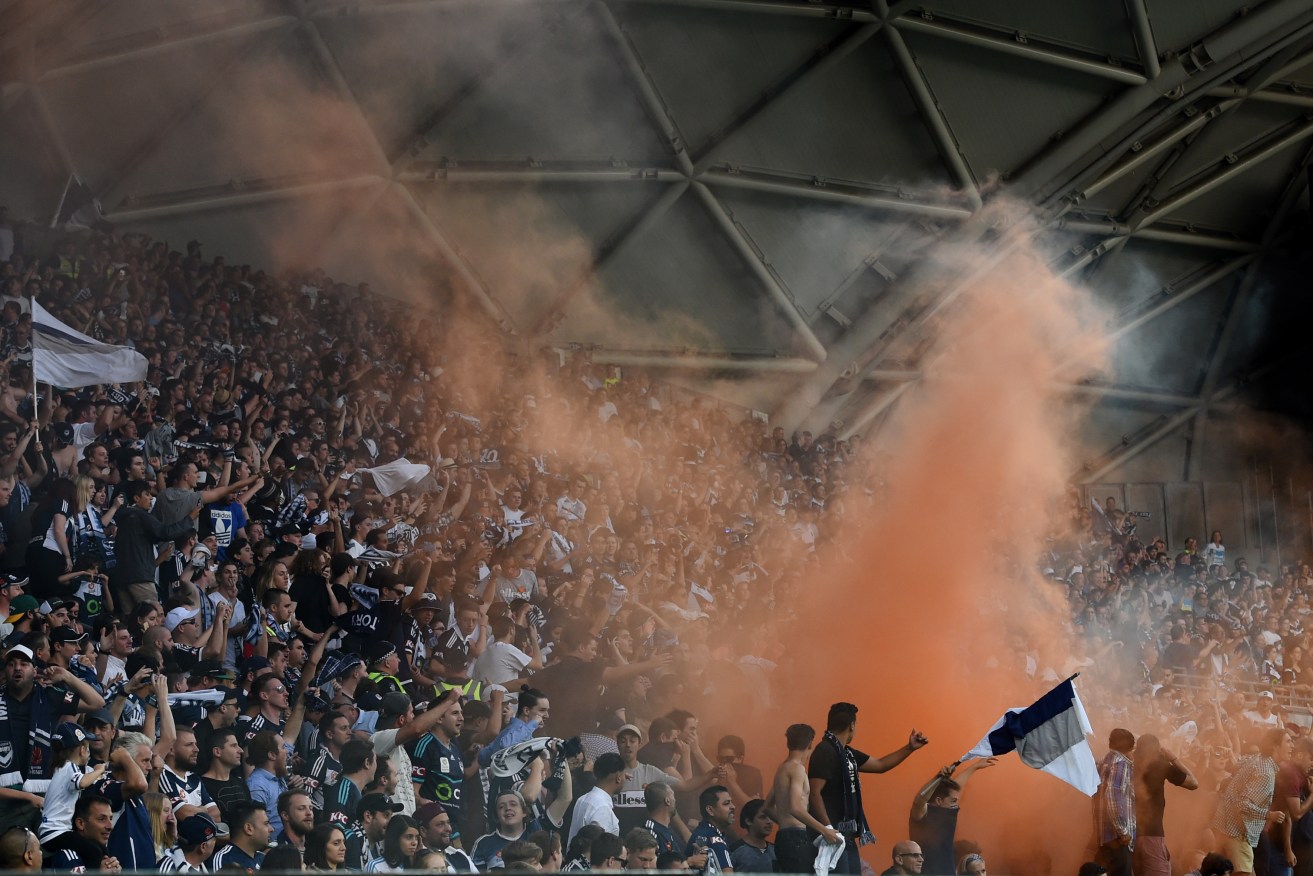 Melbourne Victory fans light a flare during the weekend's game against Melbourne City. Photo: Tracey Nearmy, AAP.