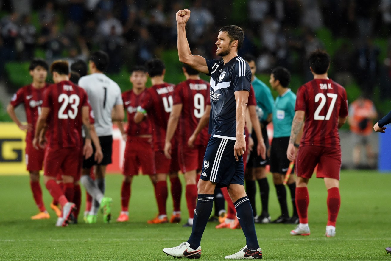 Matthieu Delpierre of the Victory celebrates their win against China's Shanghai SIPG at AAMI Park. Photo: Tracey Nearmy, AAP.