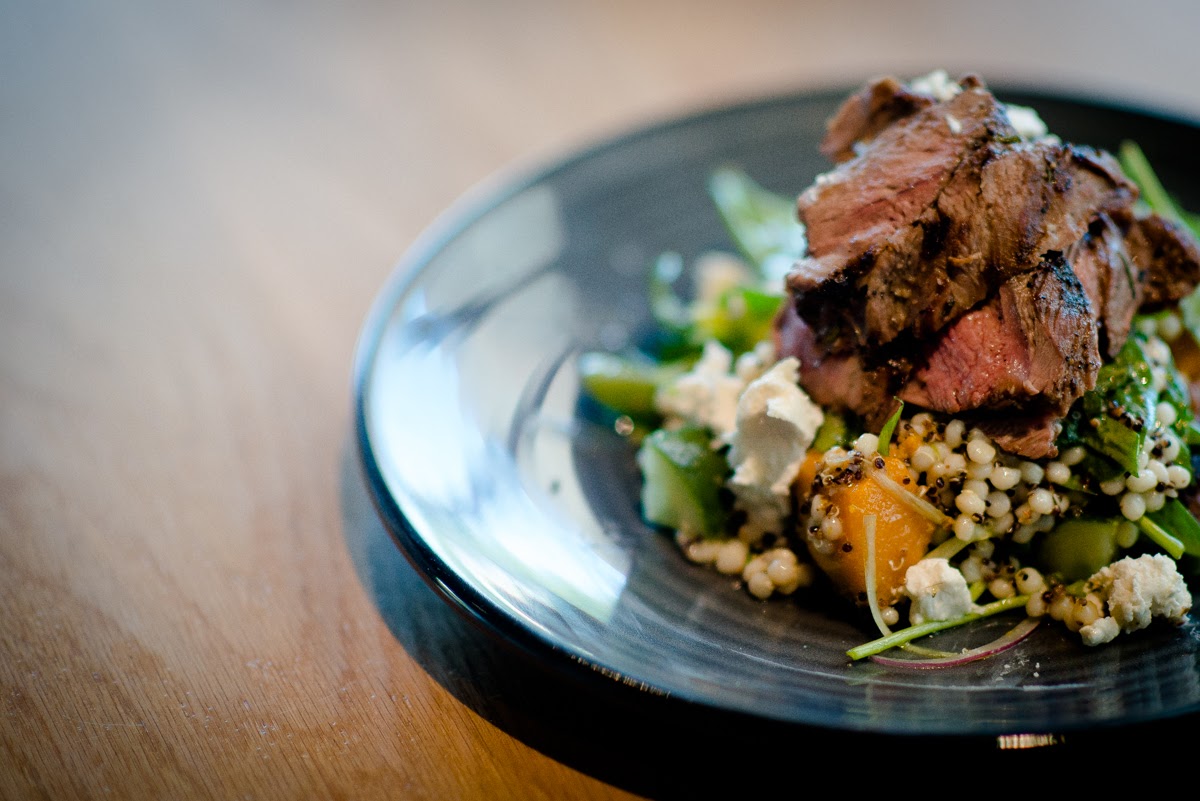 A neighbouring diner's lunch dish - Lamb rump, pumpkin, quinoa and feta salad. Photo: Nat Rogers/InDaily