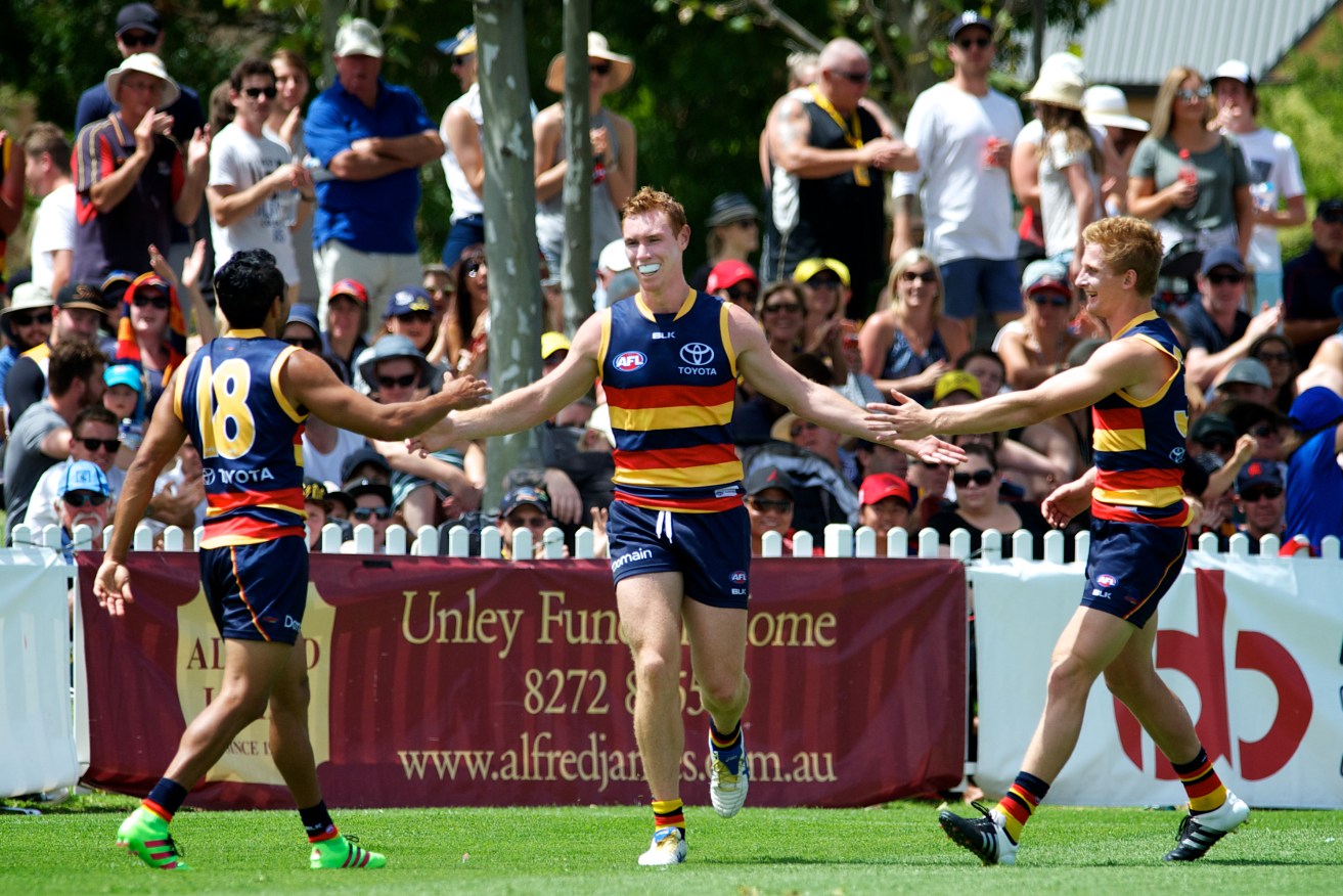 Eddie Betts and impressive new recruit Dean Gore congratulate Tom Lynch on a goal against West Coast. Photo: Michael Errey, InDaily.