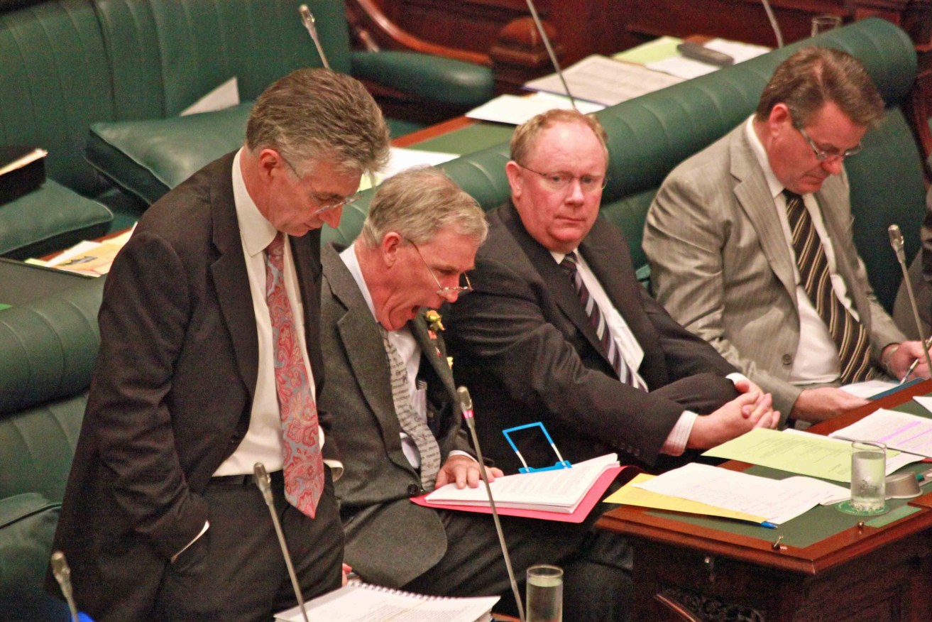 "I nicknamed him the anaesthetist." Michael Atkinson (second from left), yawns while John Hill (left) addresses Parliament.