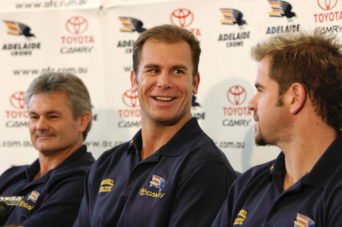Adelaide, June 24, 2004. Wayne Carey (centre) and Adelaide Crows coach Neil Craig (left)) and Crow's Captain Mark Ruccuito (right) during a press conference where Carey announced his retirement in Adelaide today. Carey retired from AFL football because of a neck injury. (AAP Image/Rob Hutchison) NO ARCHIVING
