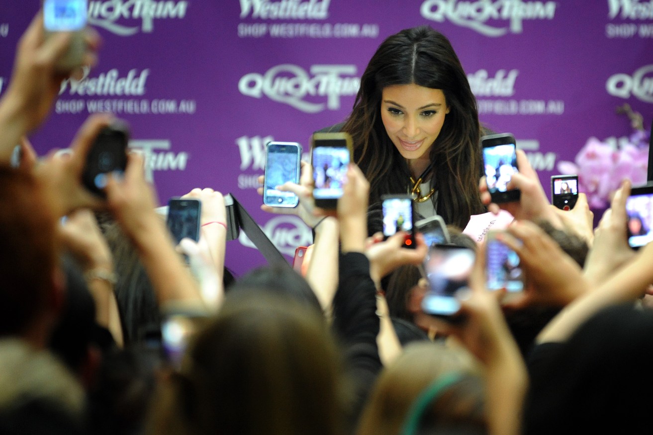 Reality TV star Kim Kardashian is greeted by fans with mobile phones, during a promotional event in Melbourne. Photo: AAP/Joe Castro