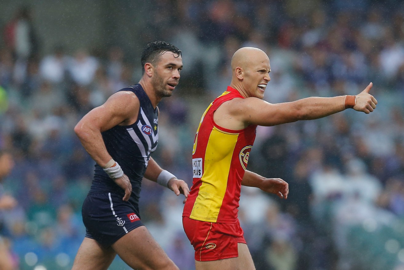 Gary Ablett tries to shake off the close attention of nemesis Ryan Crowley in his days at Freo. Photo: Theron Kirkman, AAP.