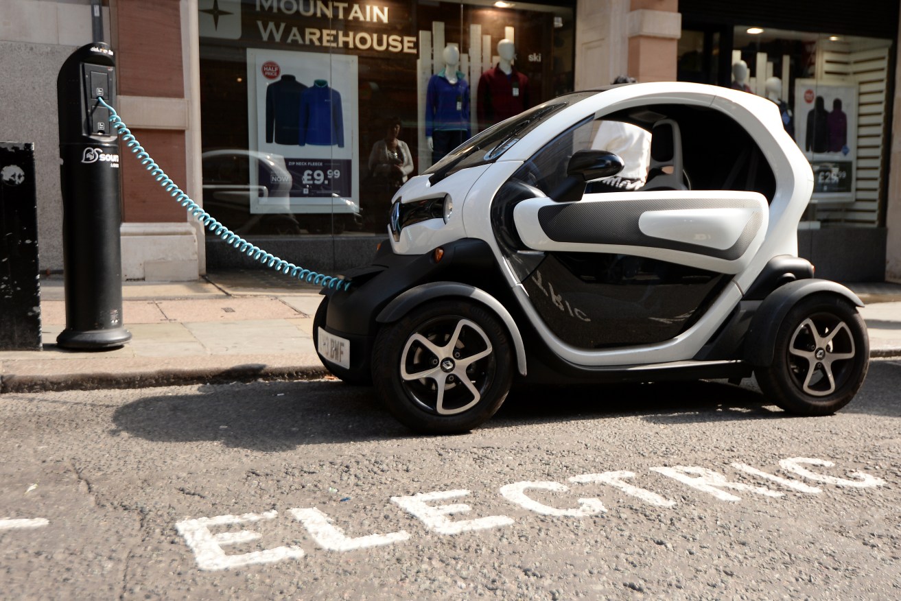 An electric Renault Twizy plugged into a charging point in London. Photo: Andrew Matthews/PA Wire