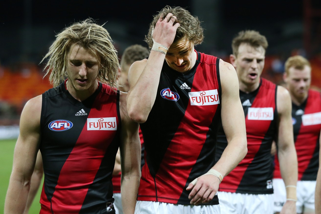 Dyson Heppell leads dejected teammates off the field after a loss to GWS last year. Photo: Craig Golding, AAP.