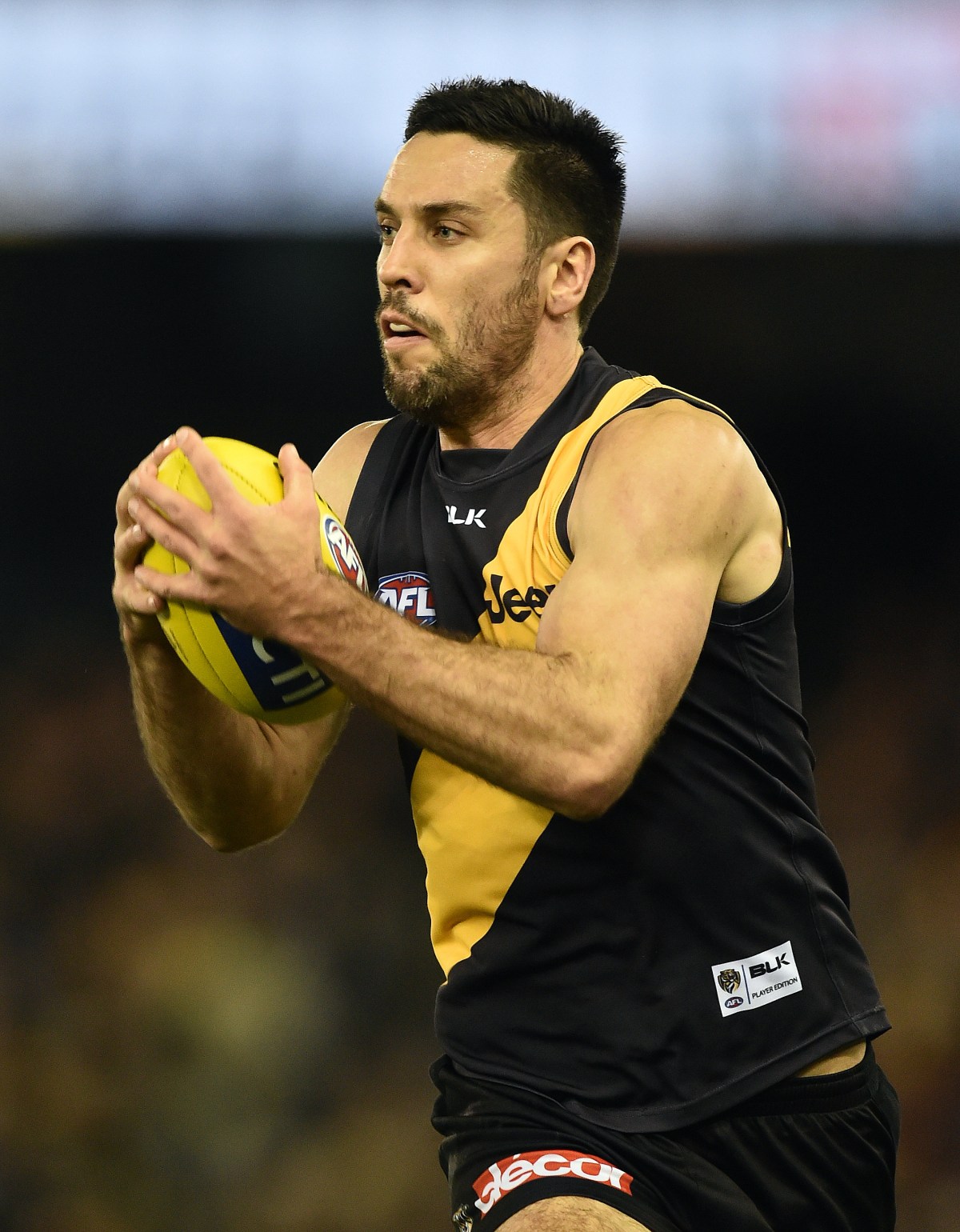 Richmond Tigers player Troy Chaplin possess the ball against the North Melbourne Kangaroos in round 23 of the AFL at Etihad Stadium, Friday, Sept. 4, 2015. (AAP Image/Julian Smith) NO ARCHIVING, EDITORIAL USE ONLY