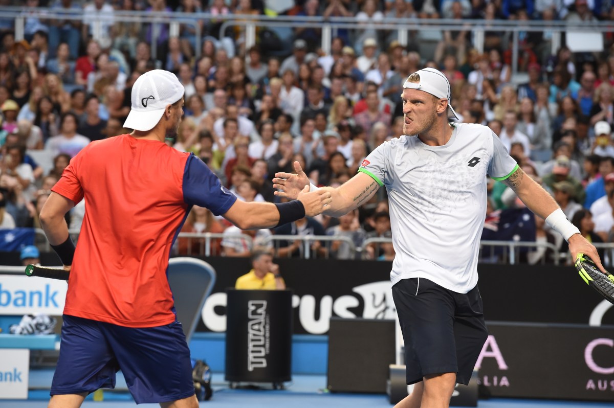 Lleyton Hewitt of Australia (left) celebrates with team mate Sam Groth of Australia after their mens doubles match against Henri Kontinen of Finland and John Peers of Australia on day six of the Australian Open tennis tournament in Melbourne, Australia, on Saturday, Jan. 23, 2016. The Australian Open tennis tournament will go from the 18th of January until the 31st of January 2016 and is Australia's foremost annual tennis event. (AAP Image/Joe Castro) NO ARCHIVING, EDITORIAL USE ONLY