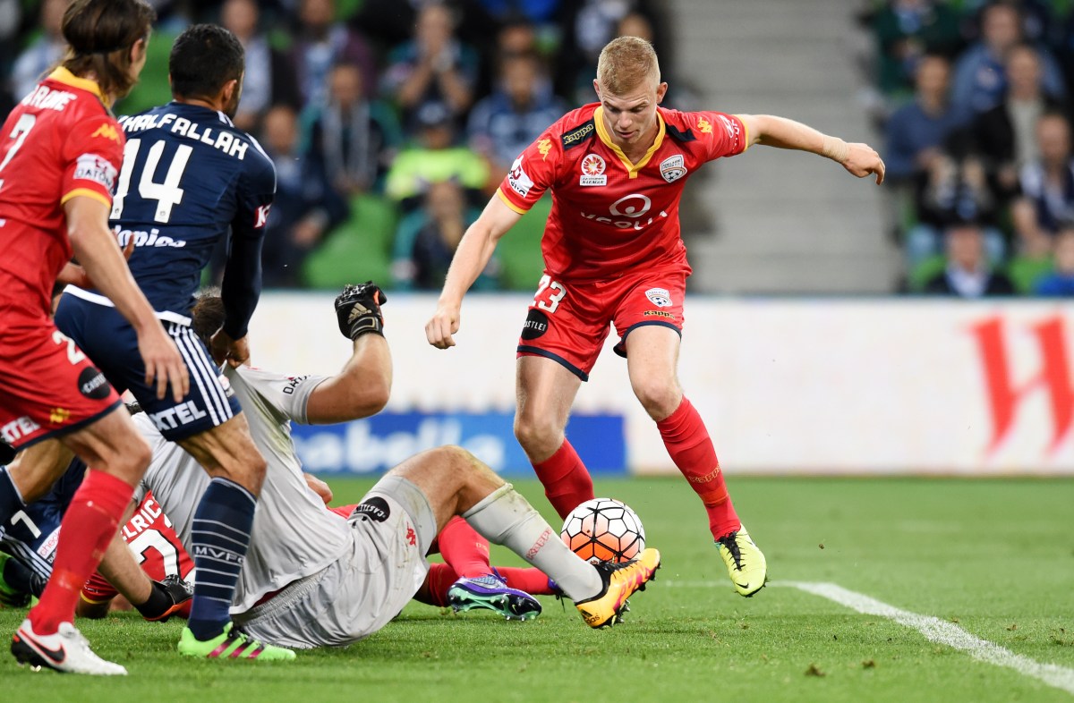 Jordan Elsey of Adelaide United tries to get the ball out of the Victory goal square during the Melbourne Victory and Adelaide United round 20 A League match at AAMI Park in Melbourne, Friday, Feb. 19, 2016. (AAP Image/Tracey Nearmy) NO ARCHIVING, EDITORIAL USE ONLY
