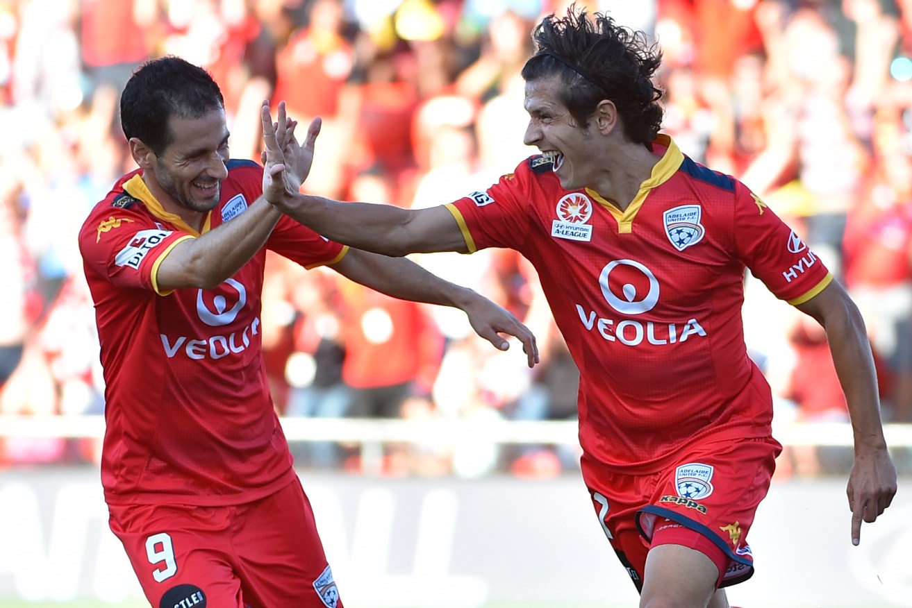 Sergio Cirio and Pablo Sanchez Alberto celebrate a goal against Brisbane Roar. Can the Reds' resurgence continue? Photo: David Mariuz, AAP.