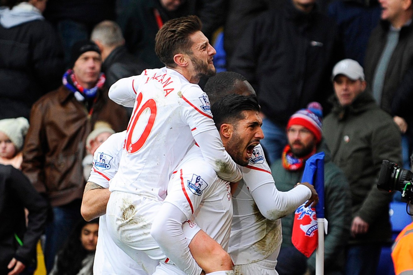 Liverpool players Adam Lallana and Emre Can celebrate their win. Photo: GERRY PENNY, EPA.   