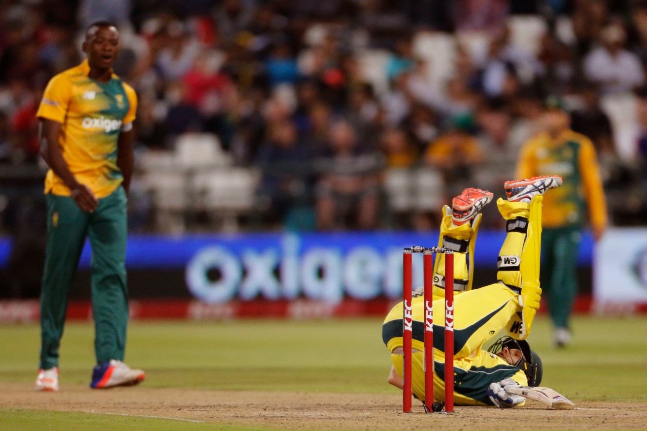 Shane Watson falls over after playing a shot against South Africa. Photo: Schalk van Zuydam, AP.