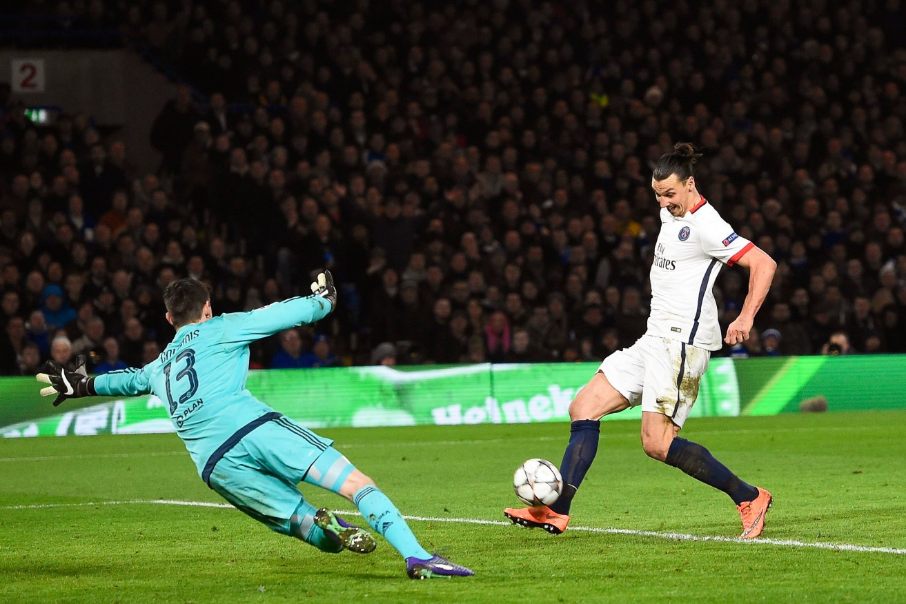 Zlatan Ibrahimovic puts the ball past goalkeeper Thibaut Courtois to put Paris Saint-Germain's 2-1 up against Chelsea. Photo: FACUNDO ARRIZABALAGA, EPA.