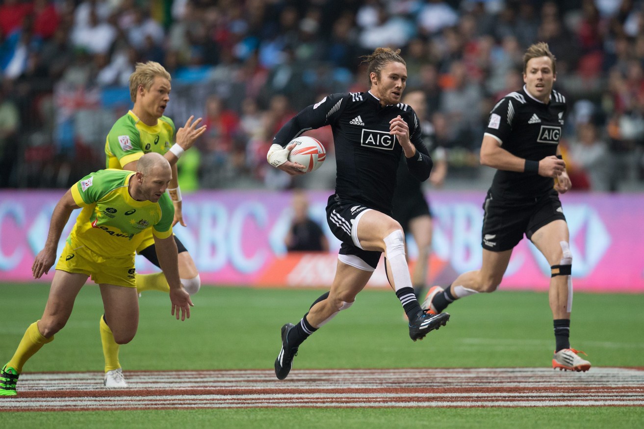 New Zealand's Gillies Kaka, flanked by teammate Tim Mikkelson, runs the ball in for a try while being chased by Australia's James Stannard (left) and Tom Kingston. Photo: Darryl Dyck, The Canadian Press/AP.