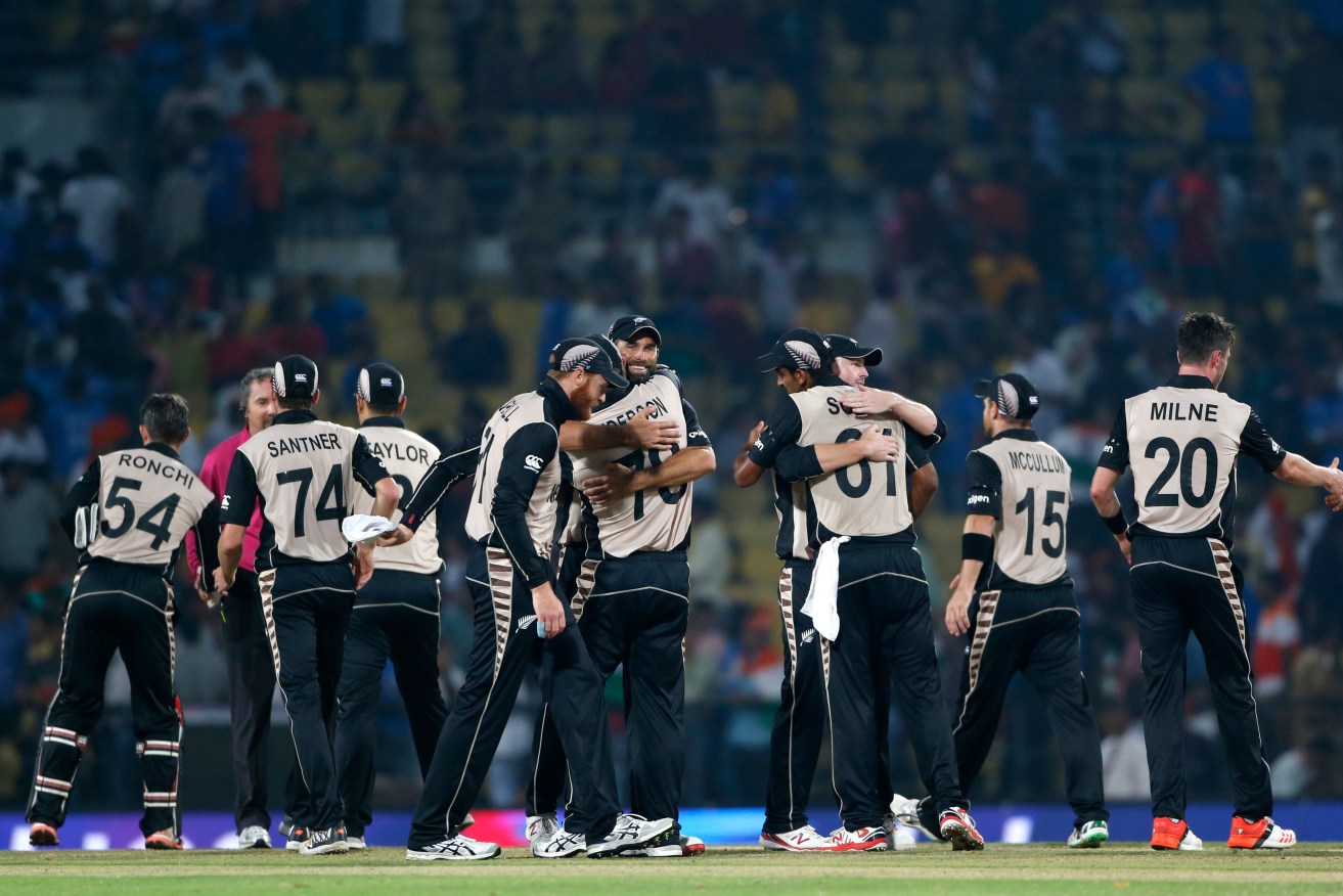 New Zealand players celebrate after defeating India by 47 runs. Photo: Saurabh Das, AP.