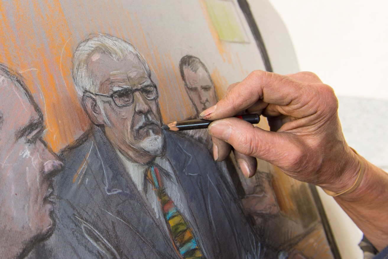 Court artist Elizabeth Cook completes a sketch showing Rolf Harris appearing by video link at Westminster Magistrates Court in London. Photo: Dominic Lipinski/PA Wire