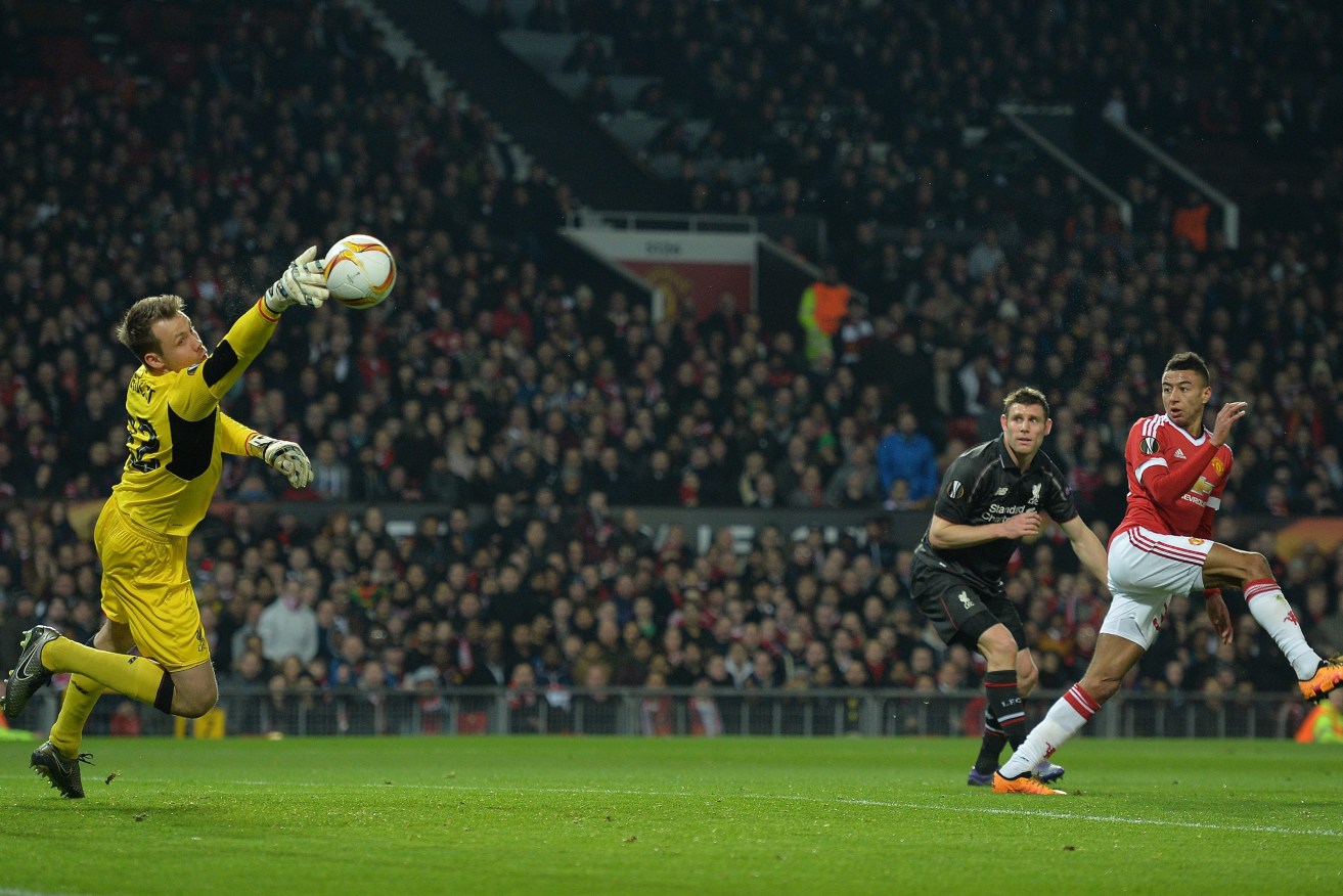 Liverpool's Simon Mignolet makes a save from Manchester United's Jesse Lingard. Photo: PETER POWELL, EPA.