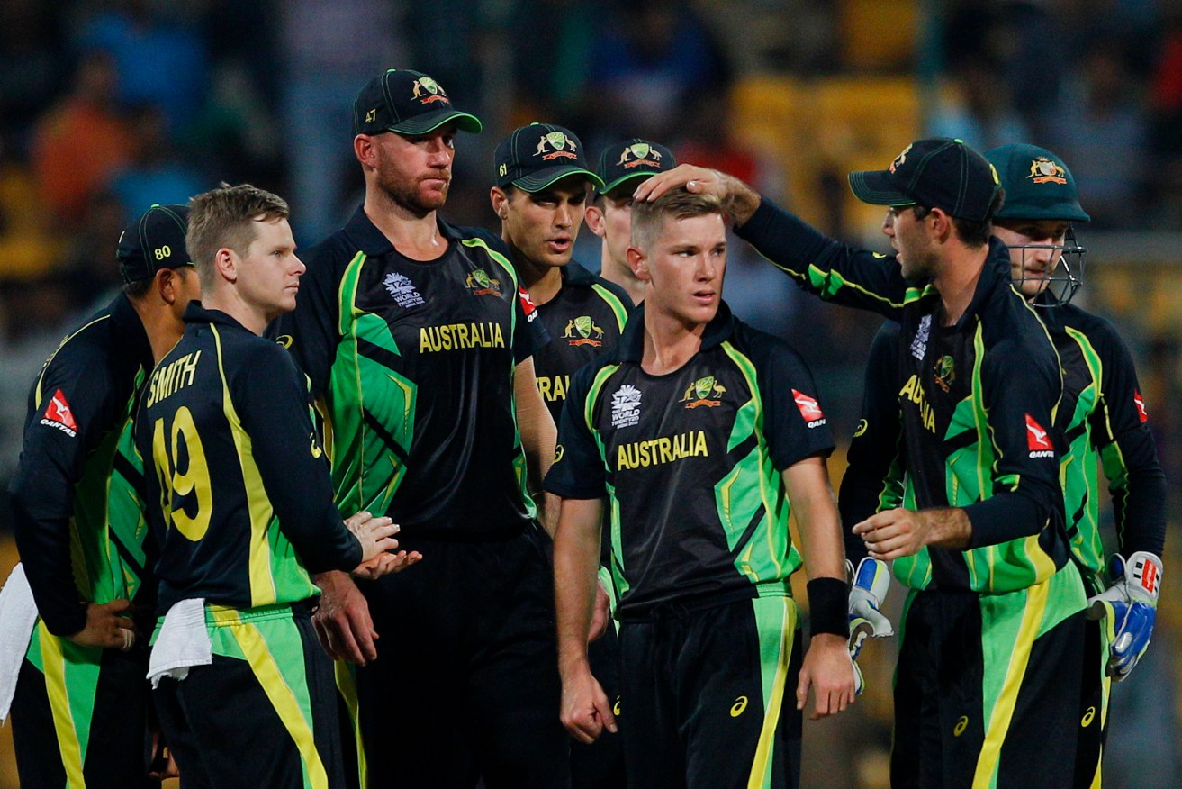 Adam Zampa is mobbed by teammates after the dismissal of Bangladesh's Shuvagata Hom - one of three wickets he took on his way to Man of the Match honours.  Photo: Aijaz Rahi, AP.