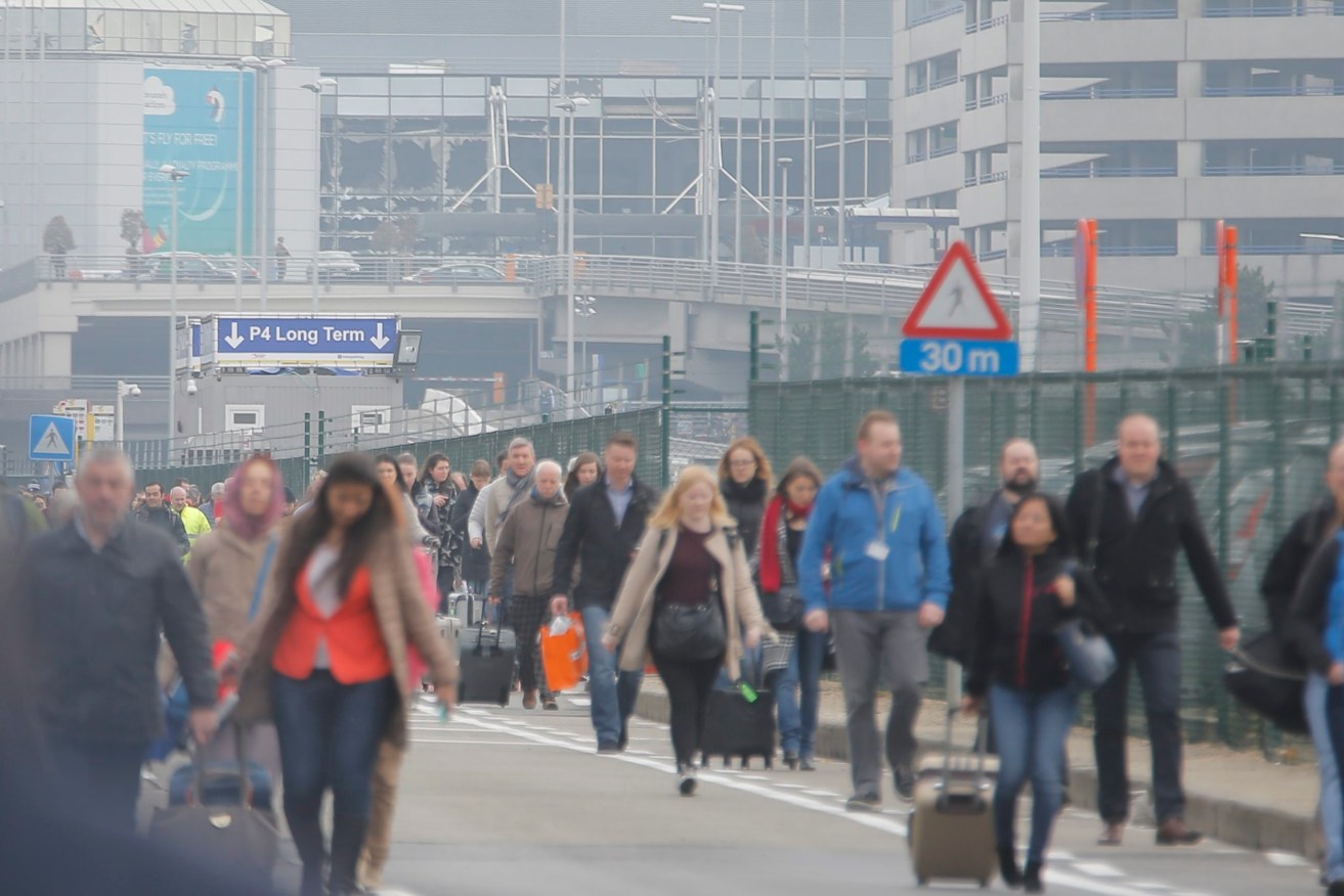 Passengers are evacuated from the terminal building after explosions at Brussels Airport. Photo:  EPA/OLIVIER HOSLET
