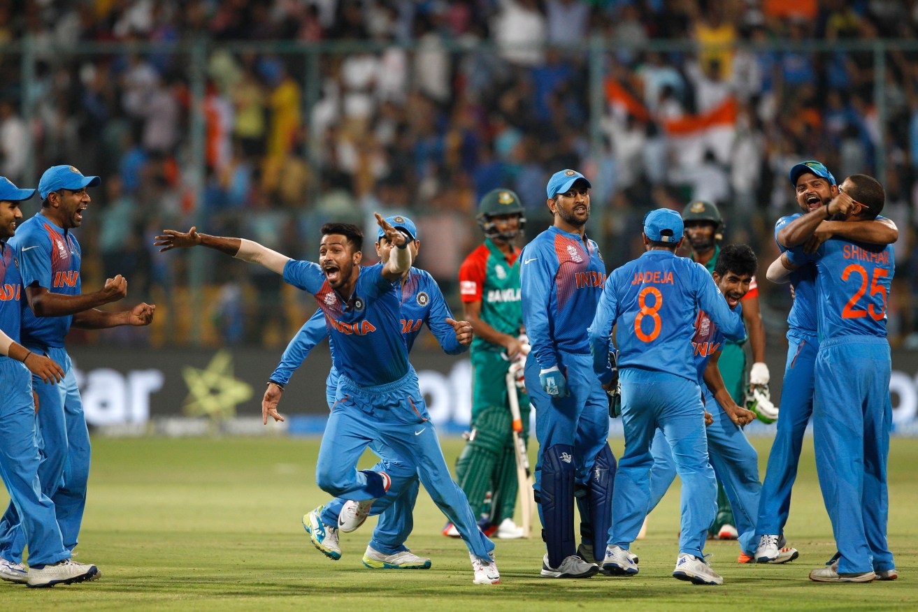 Indian cricketers celebrate after their last-gasp win against Bangladesh. Photo: Aijaz Rahi, AAP.