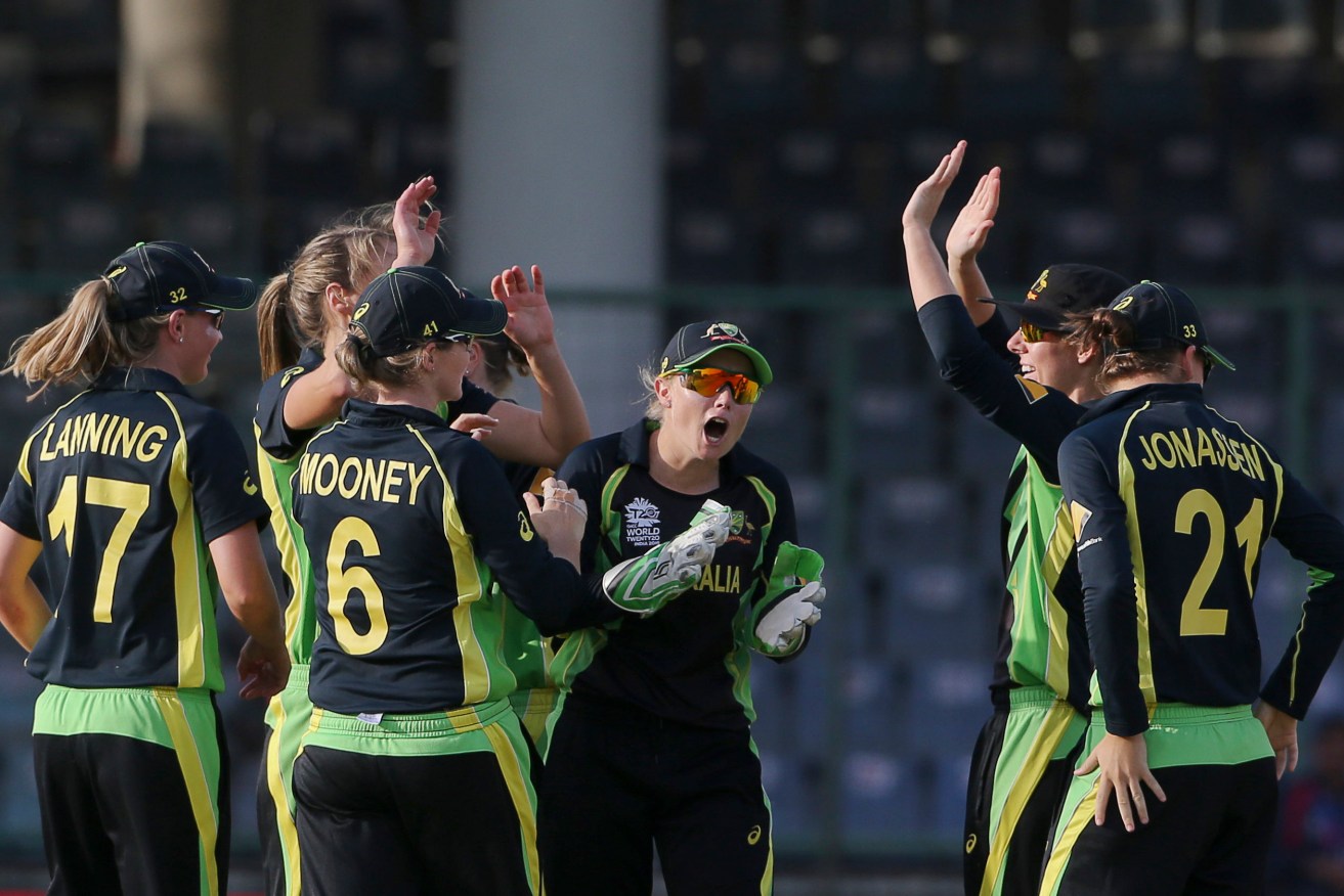 Australian players celebrate the wicket of England's Natalie Sciver. Photo: Manish Swarup, AP.
