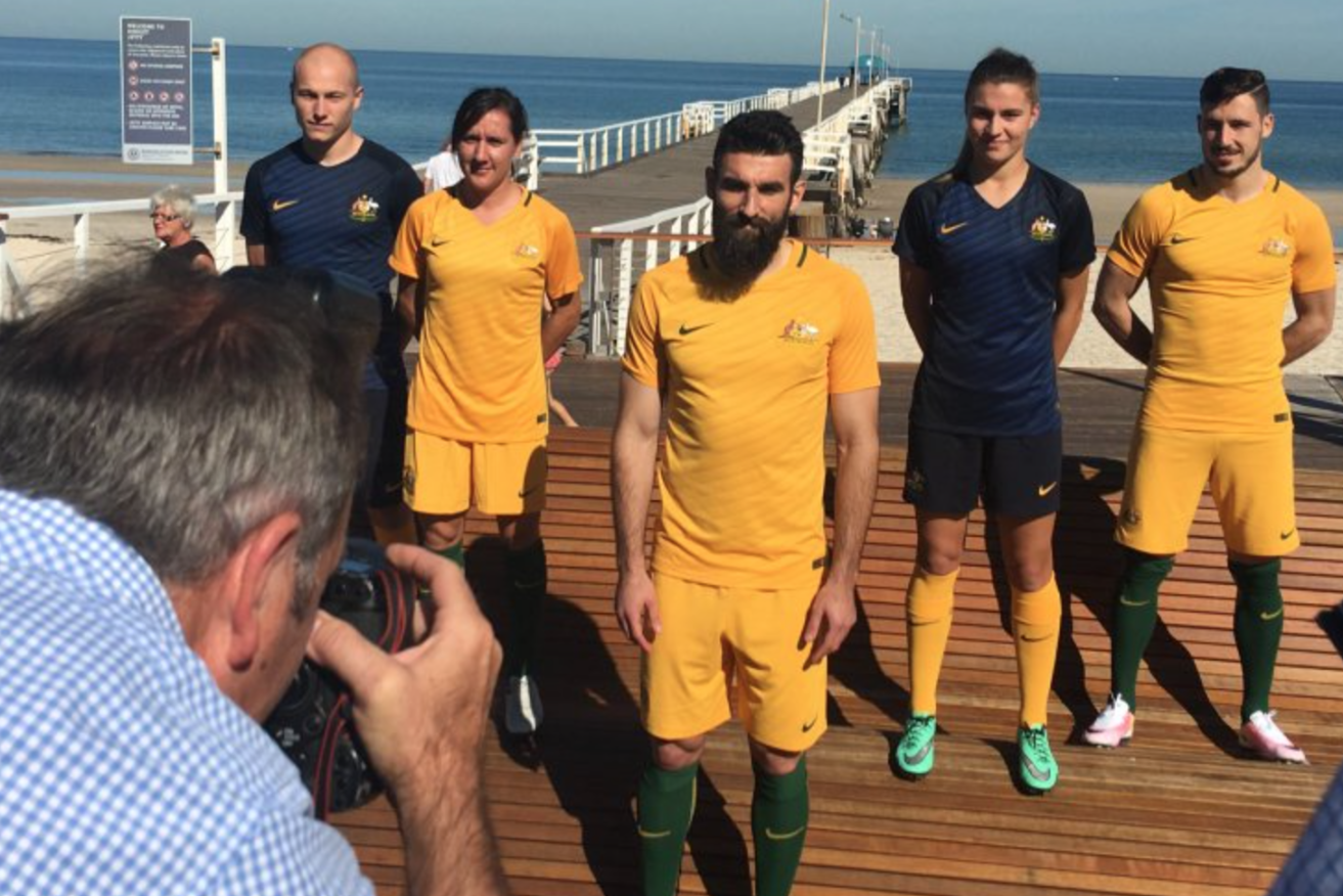 Socceroos and Matildas stars show off their new playing strip at Henley Beach. Photo: Socceroos, Twitter.