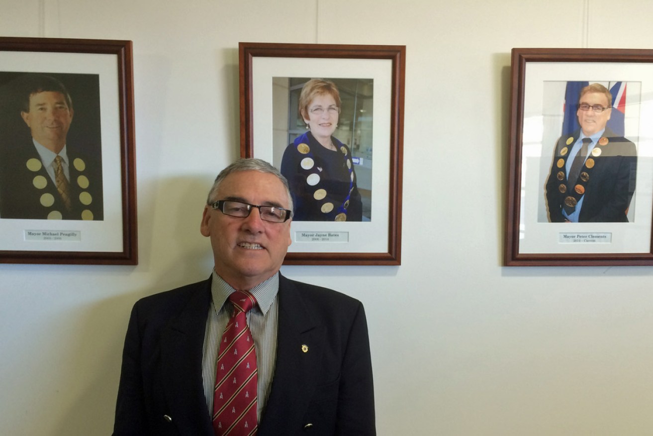 Kangaroo Island Mayor Peter Clements, with a photograph of former Mayor, now Finniss MP, Michael Pengilly (top left).