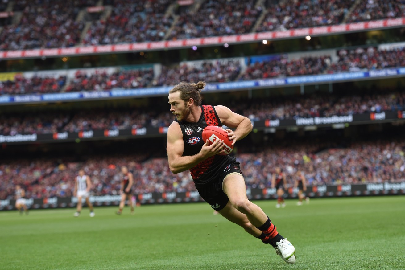 Travis Colyer in action for Essendon during last year's Anzac Day clash. He will be suspended for the re-match this long weekend. Photo: Julian Smith, AAP.
