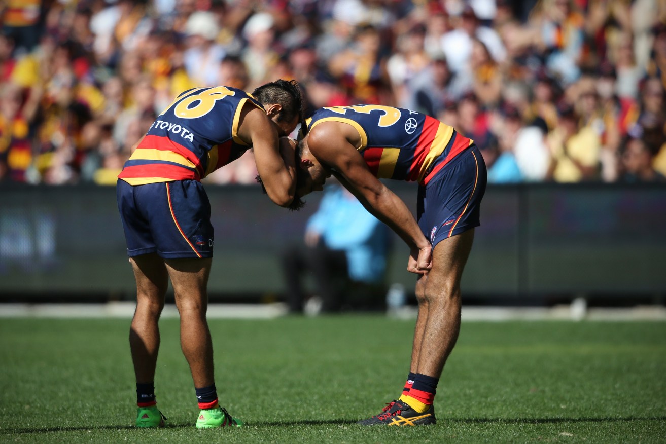 Eddie Betts shares a moment with Crows teammate Wayne Milera. Photo: Ben Macmahon, AAP.