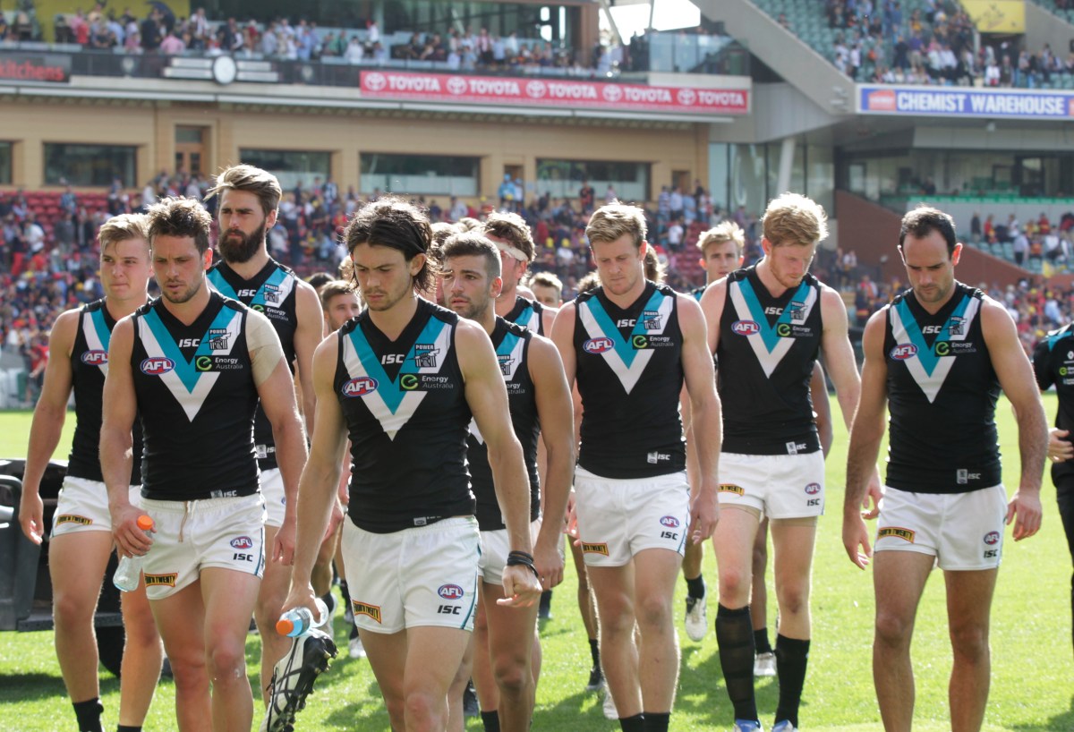 A dejected Port Adelaide team ponder a massive defeat to the Adelaide Crows 144 to 88 during the Round 2 AFL match between the Adelaide Crows and the Port Adelaide Power at Adelaide Oval, Adelaide, Saturday, April 2, 2016. (AAP Image/Ben Macmahon) NO ARCHIVING, EDITORIAL USE ONLY