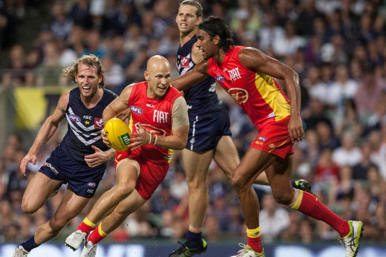 Gary Ablett takes off during Gold Coast's win over Fremantle. Photo: Tony McDonough, AAP.