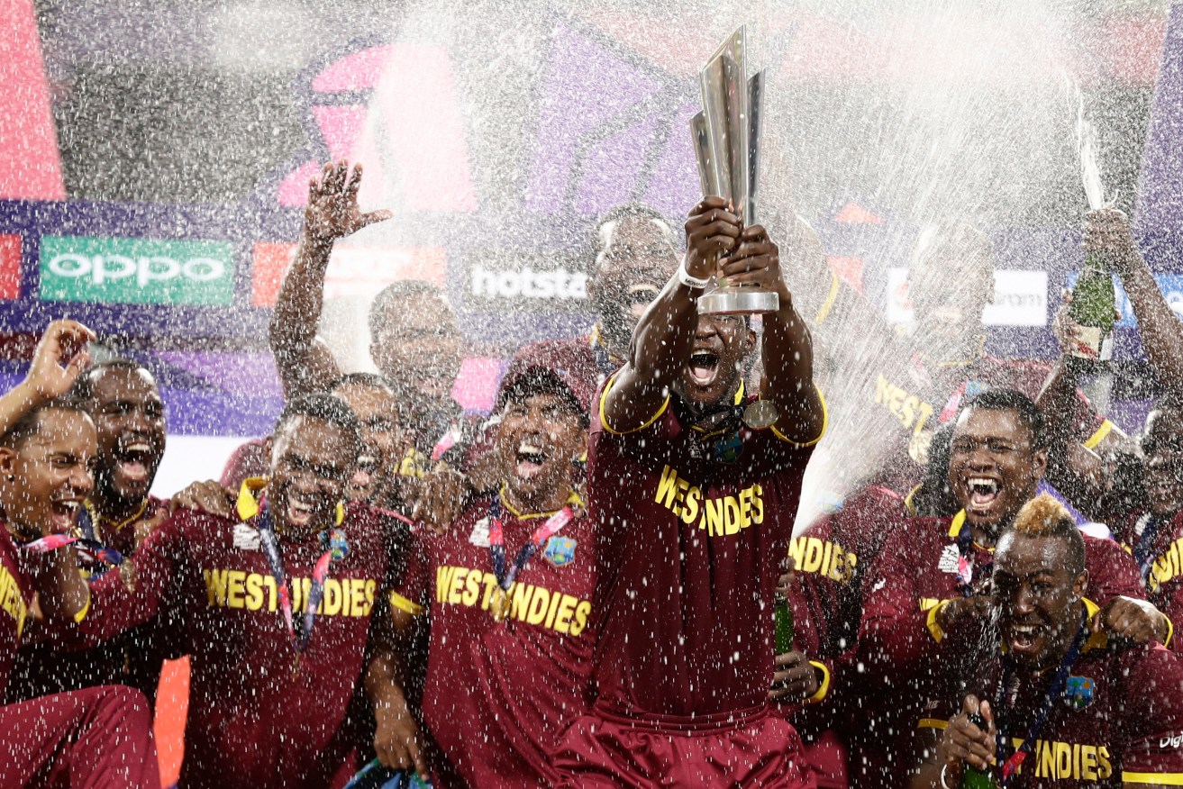 The West Indies team celebrates with their trophy on the podium after defeating England in the World T20 final. Photo: Saurabh Das, AAP.