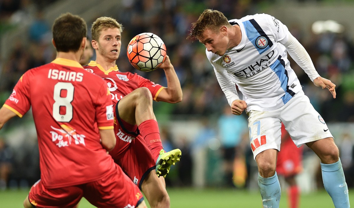 Melbourne City player Nick Fitzgerald (right) and Adelaide United players Isaias (left) and Stefan Mauk contest in round 27 of the A-League at AAMI Park in Melbourne, Friday, April 8, 2016. (AAP Image/Julian Smith) NO ARCHIVING, EDITORIAL USE ONLY