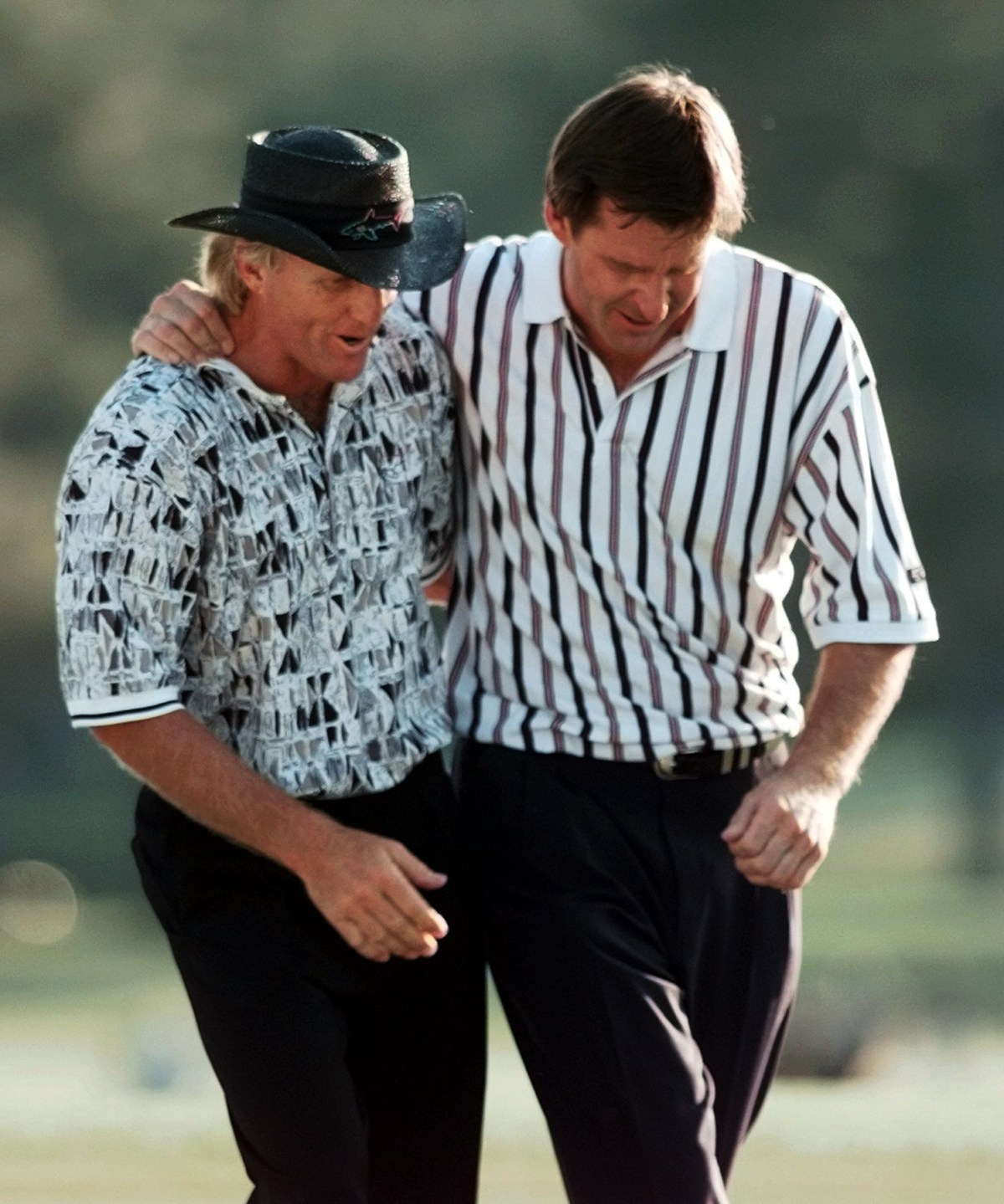 FILE - In this April 14, 1996, file photo, England's Nick Faldo, right, and Australia's Greg Norman walk off the 18th hole after Faldo won his third Masters golf tournament at the Augusta National Golf Club in Augusta, Ga. Faldo is the only multiple Masters champion to have never led going into the final round. (AP Photo/Dave Martin, File)