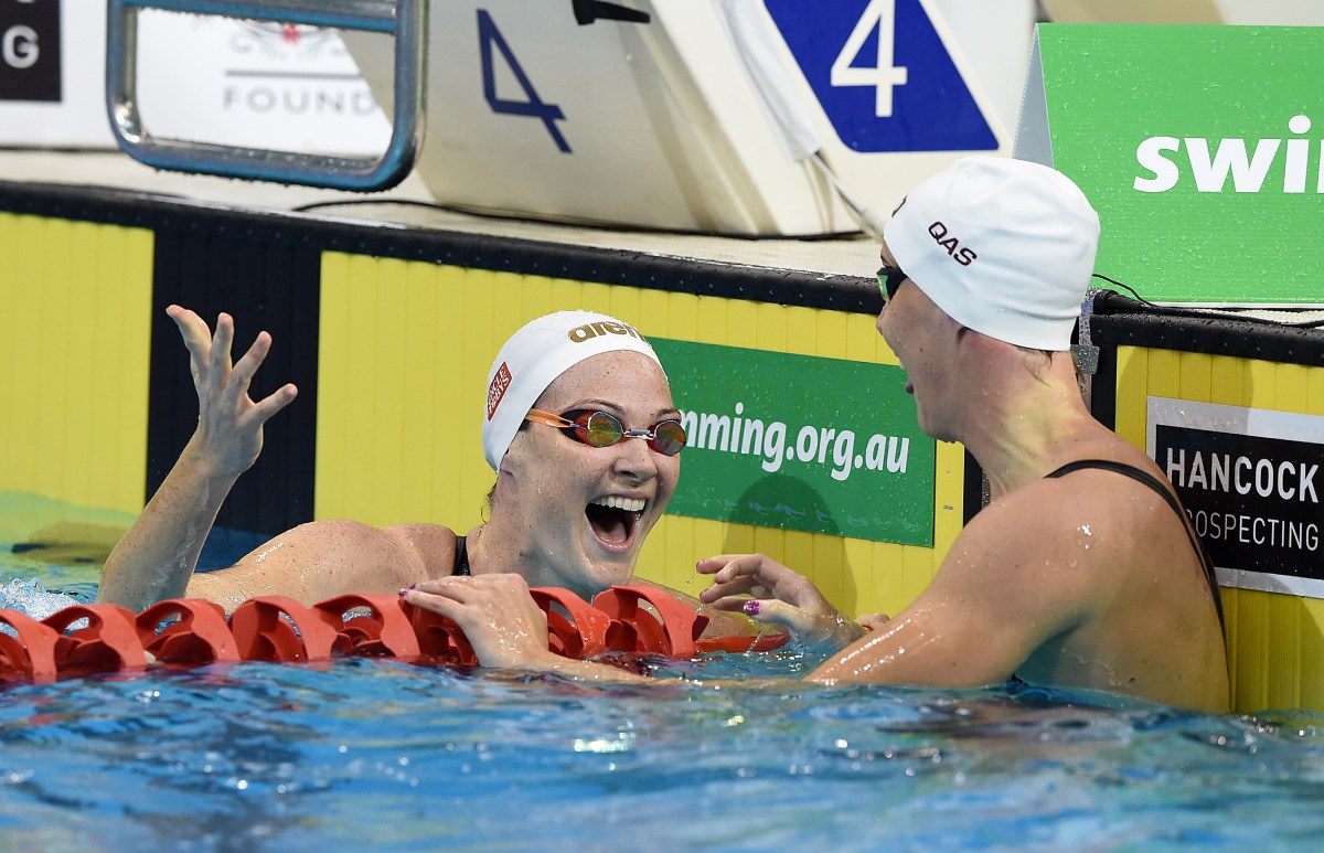 Cate Campbell (left) reacts with sister Bronte Campbell after swimming in the Women's 100m Freestyle Semi-Final on day 5 of the Australian Swimming Championships at the SA Aquatic and Leisure Centre in Adelaide, Monday, April 11, 2016. (AAP Image/Dave Hunt) NO ARCHIVING, EDITORIAL USE ONLY